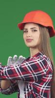 Confident female constructionist flexing biceps with a We Can Do It gesture video