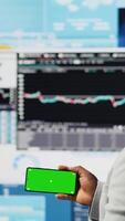 Vertical African american business leader uses green screen next to KPI metrics, ensuring company success development for a high end life. Young entrepreneur reviews fintech projections. Camera A. video