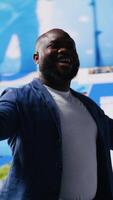 Vertical Confident black public speaker delivers guidance at a live event, presenting digital influence and e commerce at the convention. Social media feeds for web communication. Entertainment. Camera B. video