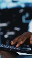 Vertical High tech concept of black IT professional exploring artificial intelligence, showcasing machine learning algorithms and systems, neural networks and futuristic data science. Camera A. video
