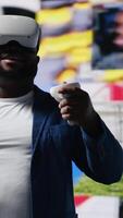 Vertical Black male expert uses high tech VR glasses for mobile feeds, showcasing engagement with digital presence, communication and interaction through application. Modern devices and platforms. Camera B. video