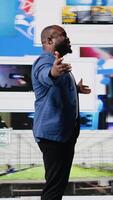 Vertical Confident black public speaker delivers guidance at a live event, presenting digital influence and e commerce at the convention. Social media feeds for web communication. Entertainment. Camera A. video