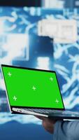 Vertical Young entrepreneur technician using advanced technology and green screen on laptop, exploring data science, automation and AI brain in a digital data visualization. Machine learning. Camera B. video