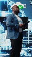 Vertical Black public speaker host presenting AI neural networks at live event, sharing insight on machine learning and predictive analytics. Young engineer presenter at tech convention. Camera A. video