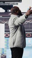 Vertical Black leader using digital graphs and analytics to improve finance models for fruitful management decisions. Professional guy optimizing performance with tech intelligence, fintech. Camera A. video