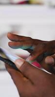 Vertical Young black user staying connected online on social network platforms, digital content and future of social engagement. Social media manager uses AI driven interactive web experience. Camera B. video