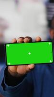 Vertical Black socials user shows a smartphone with isolated screen, digital system of networks and applications on dashboard. Highlighting the integration of AI and fintech. Multitasking. Camera B. video