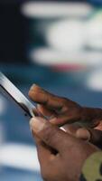 Vertical African american army staff monitoring drone and satellite imagery to collect information, finding enemy position helpful for war planning. National defense mission operations. Camera B. video