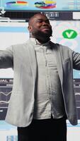Vertical Young black administrator leads visionary business pitch at event, inspiring the audience to increase performance metrics. Businessman public speaker doing a speech at the convention. Camera A. video