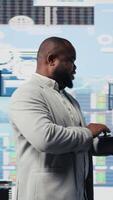 Vertical Business expert reviewing digital dashboard with finance models and projections, working on strategic planning with infographics on gadget. Corporate economy management and analysis. Camera A. video