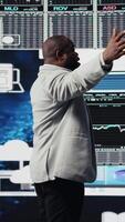Vertical Black entrepreneur thinking about a new projection to increase revenue, evaluating infographics and financial reports with digital tech tools and analytics. Success and development. Camera A. video