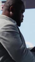 Vertical African american businessman contemplating about new powerful ideas to obtain funds, data insights for the financial and KPI projections decision making. Forecasting for productivity. Camera B. video