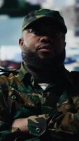 Vertical Black soldier operating in a virtual war zone using digital technology and threat detection tools, showcasing modern military strategy. Secure communications in active operations. Camera B. video