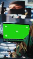 Vertical African american trooper holding laptop with copy space screen in a control tower, using modern digital tools and satellite imagery to ensure a successful national defense matter. Camera A. video