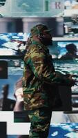 Vertical Black veteran reviewing battlefield data in a high tech command center, ensuring war planning through tactics and geopolitics details. Modern army environment focused on protection. Camera A. video