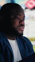 Vertical African american person deals with consequences of overusing social networks, faces stress and mental health due to digital dependence. Facing harmful toxic information overload. Camera B. video