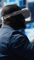 Vertical Digital tech expert coding and using VR headset at innovation hub, showcasing the intersection of data science and cybersecurity. Coding life immersed in high tech code development. Camera B. video