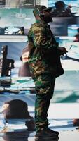 Vertical African american man transmitting crucial battlefield information to soldiers, reviewing satellite data in a high tech command center. War planning through tactics for protection. Camera A. video