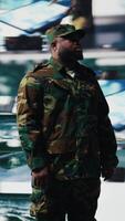 Vertical African american military soldier engaged in tactical command and surveillance activity, collect intelligence for AI warfare systems efficiency in a national defense mission. Camera A. video