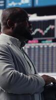 Vertical Male business leader analyzing finance charts and analytics for startup development, performance models for fruitful management decisions. Administrator studying big data reports. Camera B. video