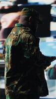 Vertical African american soldier works in command center with satellite data for surveillance, collecting intelligence for tactics and war planning in a national defense mission. Armed forces. Camera B. video