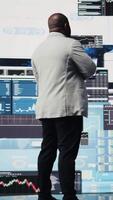 Vertical Male business leader analyzing finance charts and analytics for startup development, performance models for fruitful management decisions. Administrator studying big data reports. Camera A. video