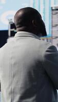 Vertical African american professional reviews financial charts and KPI projections, business performance and innovation with strategic insight through fintech materials and forecasting tools. Camera B. video