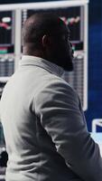 Vertical Modern business manager thinking about new successful ideas to increase his profit and develop the company, using insight and KPI projections or models for strategic decision making. Camera B. video