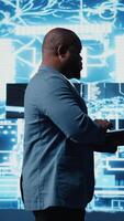 Vertical Digital concept of African American engineer exploring artificial intelligence, showcasing deep learning algorithms, high tech neural networks and futuristic data structures. Camera A. video
