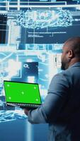 Vertical Modern black person in digital space uses isolated display with AI tools, representing artificial intelligence data structures and intelligent systems. Innovation and cybernetics for science. Camera A. video