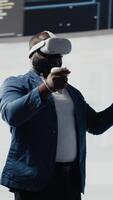 Vertical African American programmer engaging in virtual reality with a headset, focusing on system development. Utilizing code on terminal window to debug and design new software. IT career. Camera B. video