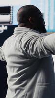Vertical Black leader using digital graphs and analytics to improve finance models for fruitful management decisions. Professional guy optimizing performance with tech intelligence, fintech. Camera B. video
