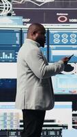 Vertical African american entrepreneur chatting on the phone call with a new vision for business development, working hard for performance metrics. Forecasting and project planning for growth. Camera A. video