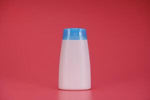 White Blank Label Shampoo Bottle or Shower Gel on Pink Background photo