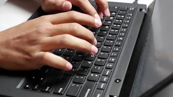 Close-up of hands typing on a laptop keyboard in a bright indoor workspace video
