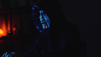 Underground hacker in hoodie working on laptop symbolizing cybercrime and anonymous data access video