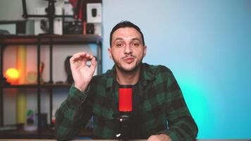 Modern Podcaster Speaking to Camera in Bright Studio Environment with High-Quality Microphone video