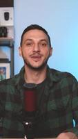 Man Talking into Microphone While Recording Solo Podcast Episode at Home Using Vertical Framing for Mobile Platforms video