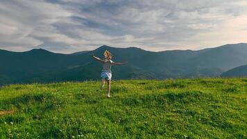 Teenage Girl Running on Lush Mountain Meadow, Sunset Light Spreads Across Layers of Carpathian Ridges video