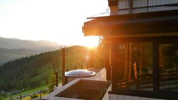 Modern Wooden House in Carpathians at Sunset, Mountain View and Warm Light Reflecting video