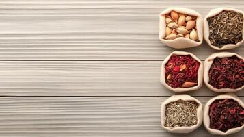 Various Dried Herbs Bloom and Seeds Displayed in Small Burlap Sacks on Wooden Surface Concept for Zero Waste Living photo