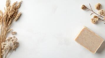 Bar soap and dried plants on bright surface. Concept of zero waste living and sustainable lifestyle. Clean body care product with herbal elements. photo