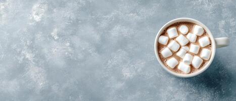 Cup with low carb dessert on grey surface. Gluten free sweet drink with white marshmallows. Delicious and diet dessert on background. photo