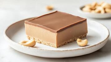 Square layered treat with nuts on plate. Light background shows gluten free low carb dessert with crunchy base and topping. photo