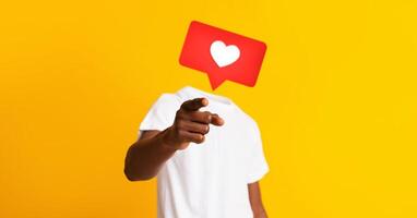 A person in a white shirt gestures with a pointing finger against a bright yellow background, featuring a heart icon instead of their head, depicting social media engagement and connection. photo