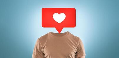 A creative representation shows a person without a head, replaced by a red speech bubble featuring a heart icon. This artwork conveys themes of social media interaction and emotional expression. photo
