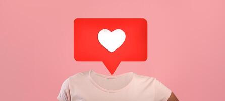 A unique design features a red heart icon inside a speech bubble over human body, using a pink background to symbolize social media interactions. photo