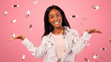 Choice options for holiday sale. Cheerful black woman comparing variants, advertising products, holding invisible objects on pink studio background with falling confetti, mockup for design photo