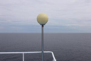 A light pole on a boat with a yellow light on it photo