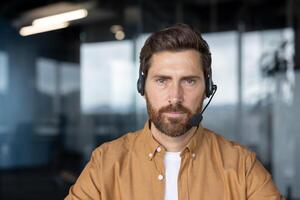 Confident customer service representative wearing headset in modern office. Professional, focused demeanor suitable for customer support, communication solutions, call center environments, business. photo